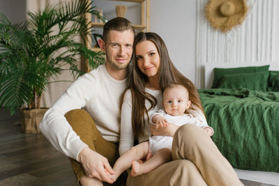 Portrait of a happy family with a young son at home