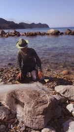 Man kneeling at beach