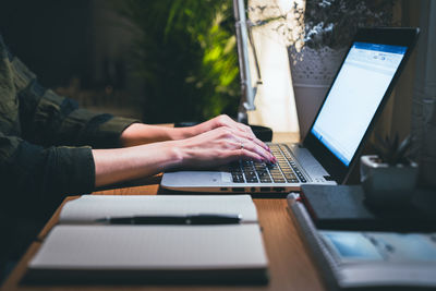 Woman hands typing on laptop on table. focus on hands typing. work from home concept