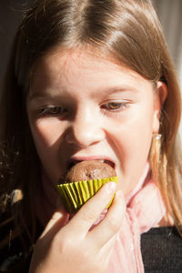 Close-up of girl eating cupcake