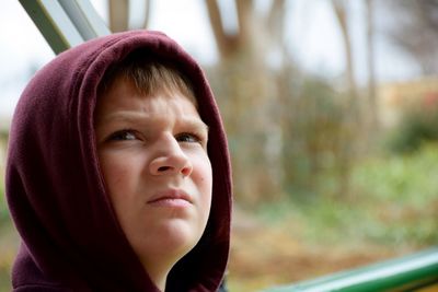 Close-up of thoughtful boy in hood