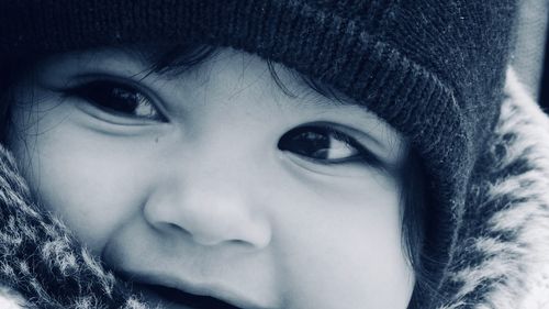 Close-up portrait of cute girl in snow