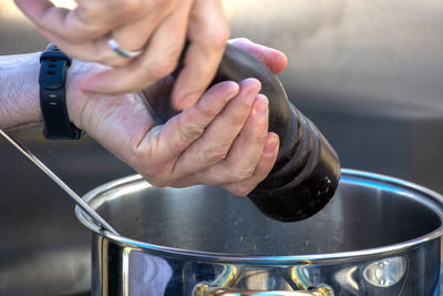 Cropped hand of person welding metal