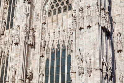 Marble sculptures of catholic cathedral . white gothic church in milan italy