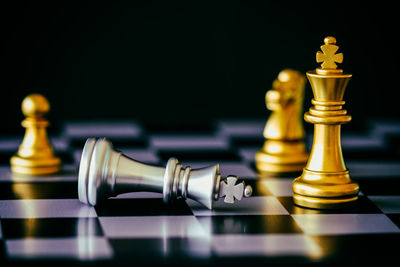 Close-up of chess pieces against black background