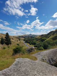 Scenic view of river by mountains against sky