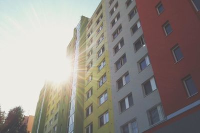 Low angle view of sun shining through building