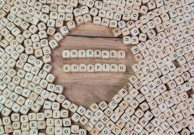 Directly above shot of internet shopping text amidst wooden cubes