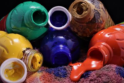High angle view of multi colored bottles on table