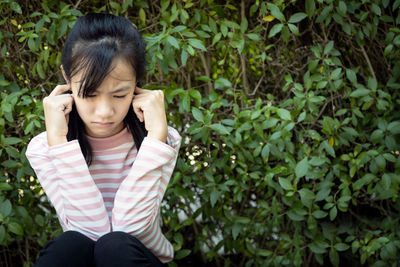 Low section of a girl sitting outdoors