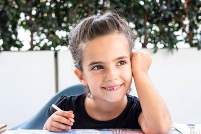 Smiling cute girl studying at table