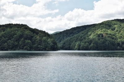 Scenic view of lake and mountains against sky