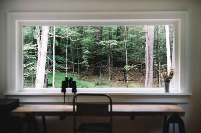 Rear view of people sitting in glass window