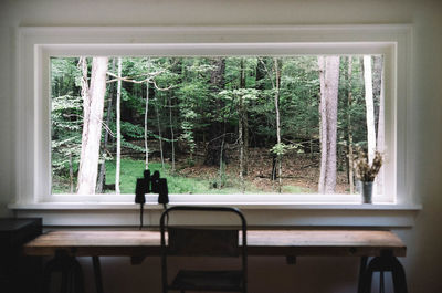 Rear view of people sitting in glass window