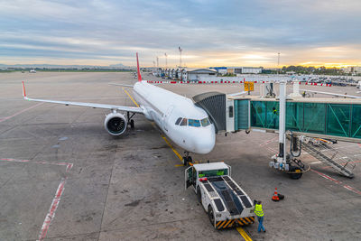 High angle view of airplane on airport runway against sky