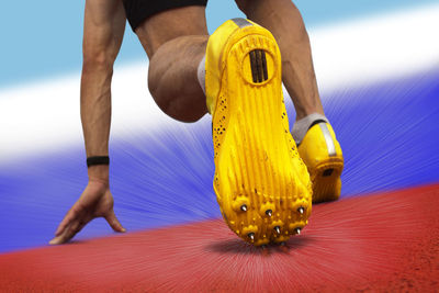 Low section of man against yellow sky