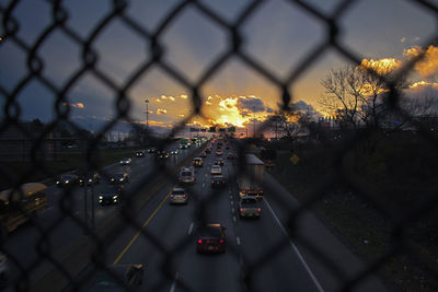 Cars on road in city against sky