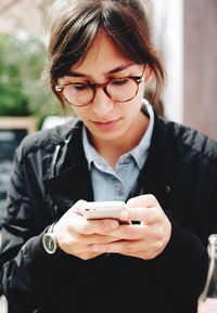 Close-up of young woman using mobile phone