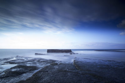 Scenic view of sea against cloudy sky