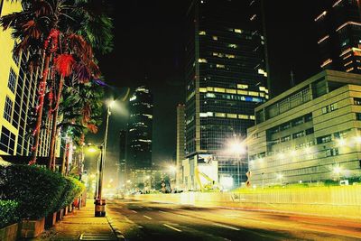 Illuminated city street at night