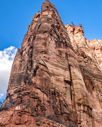 Low angle view of rock formations against clear blue sky