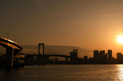 Scenic view of sea against sky during sunset at rainbow bridge in tokyo