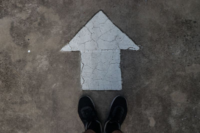 Low section of person standing on road