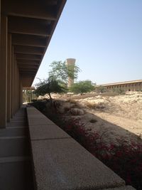 Footpath amidst buildings against clear sky