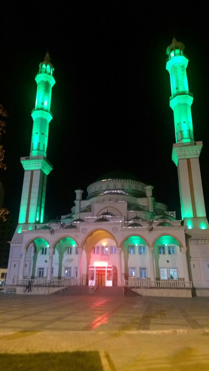 illuminated, architecture, night, built structure, building exterior, arch, clear sky, lighting equipment, copy space, street light, blue, facade, low angle view, architectural column, travel destinations, outdoors, famous place, column, history, tourism