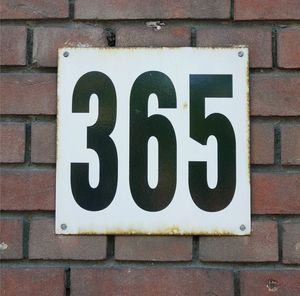 Close-up of information sign on wall