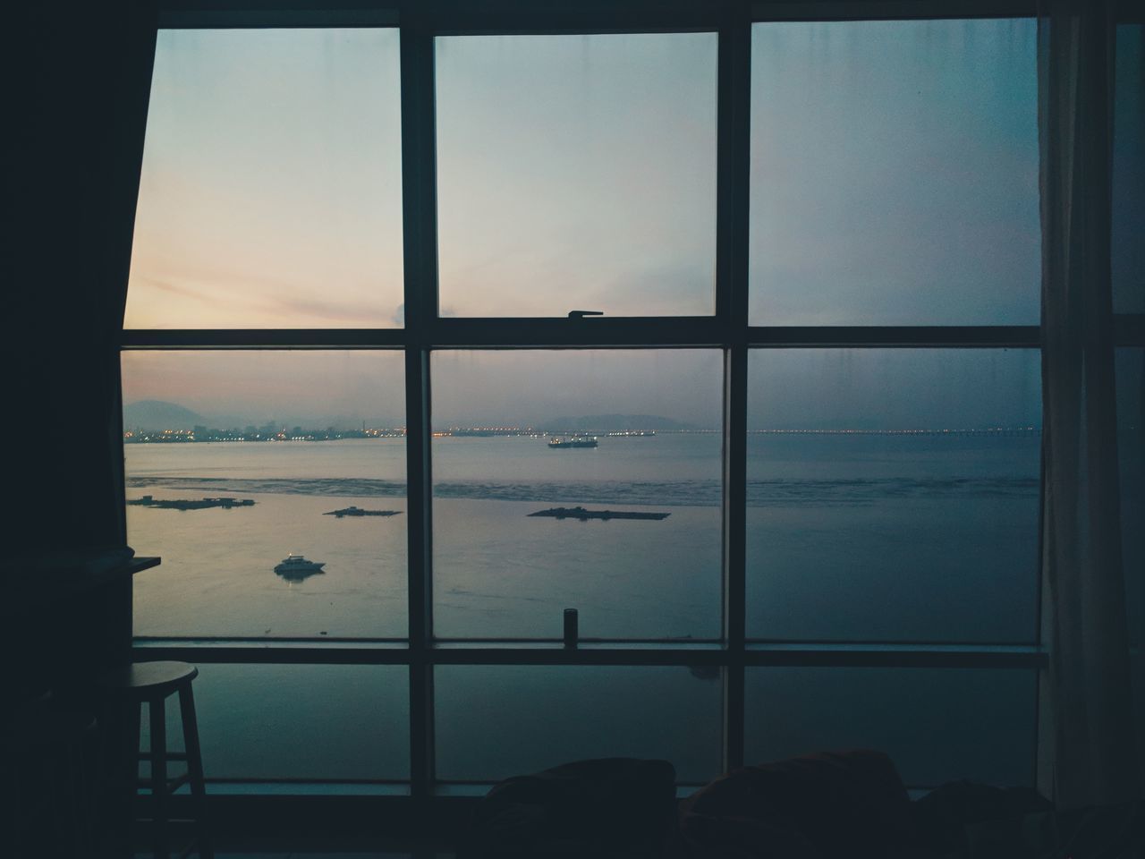 SCENIC VIEW OF SEA AGAINST SKY SEEN THROUGH WINDOW