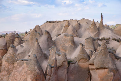 Low angle view of rock formations against sky