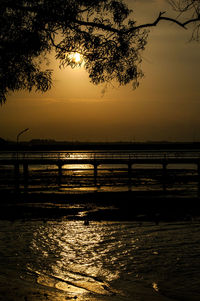 Scenic view of river at sunset