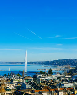 High angle view of cityscape against blue sky