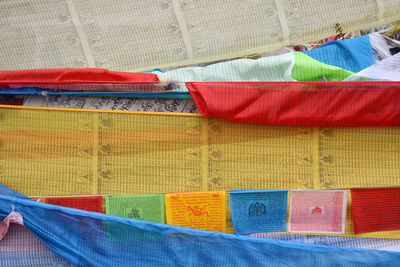 High angle view of multi colored umbrellas hanging at market stall