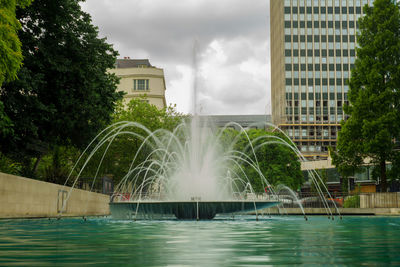 View of fountain against cloudy sky