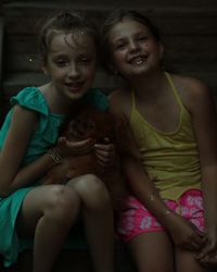 Mother and girl sitting outdoors