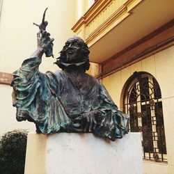 Statue against building