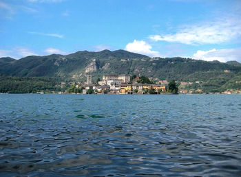 Scenic view of lake and mountains against blue sky