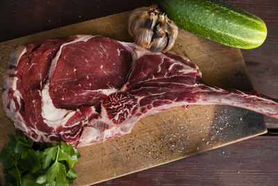 High angle view of meat on cutting board at table