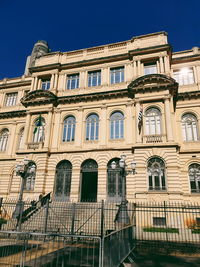 Low angle view of building against clear blue sky