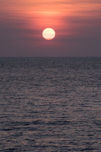 Scenic view of sea against romantic sky at sunset