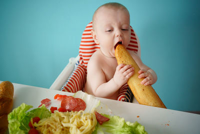 Child eats baguette