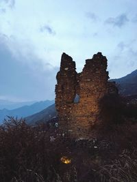 Low angle view of rock formation against sky