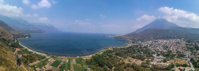 High angle view of sea and cityscape against sky