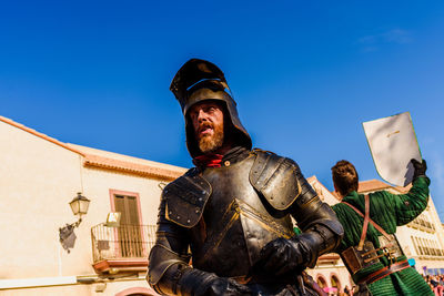 Low angle view of statue against clear blue sky