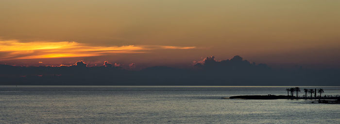 Scenic view of sea at sunset