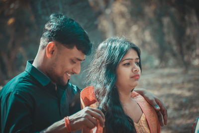 Portrait of young couple holding hands