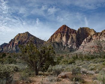 Scenic view of mountain against cloudy sky