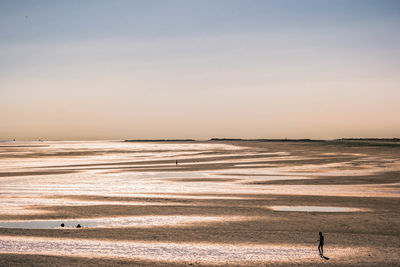 Scenic view of beach against sky during sunset